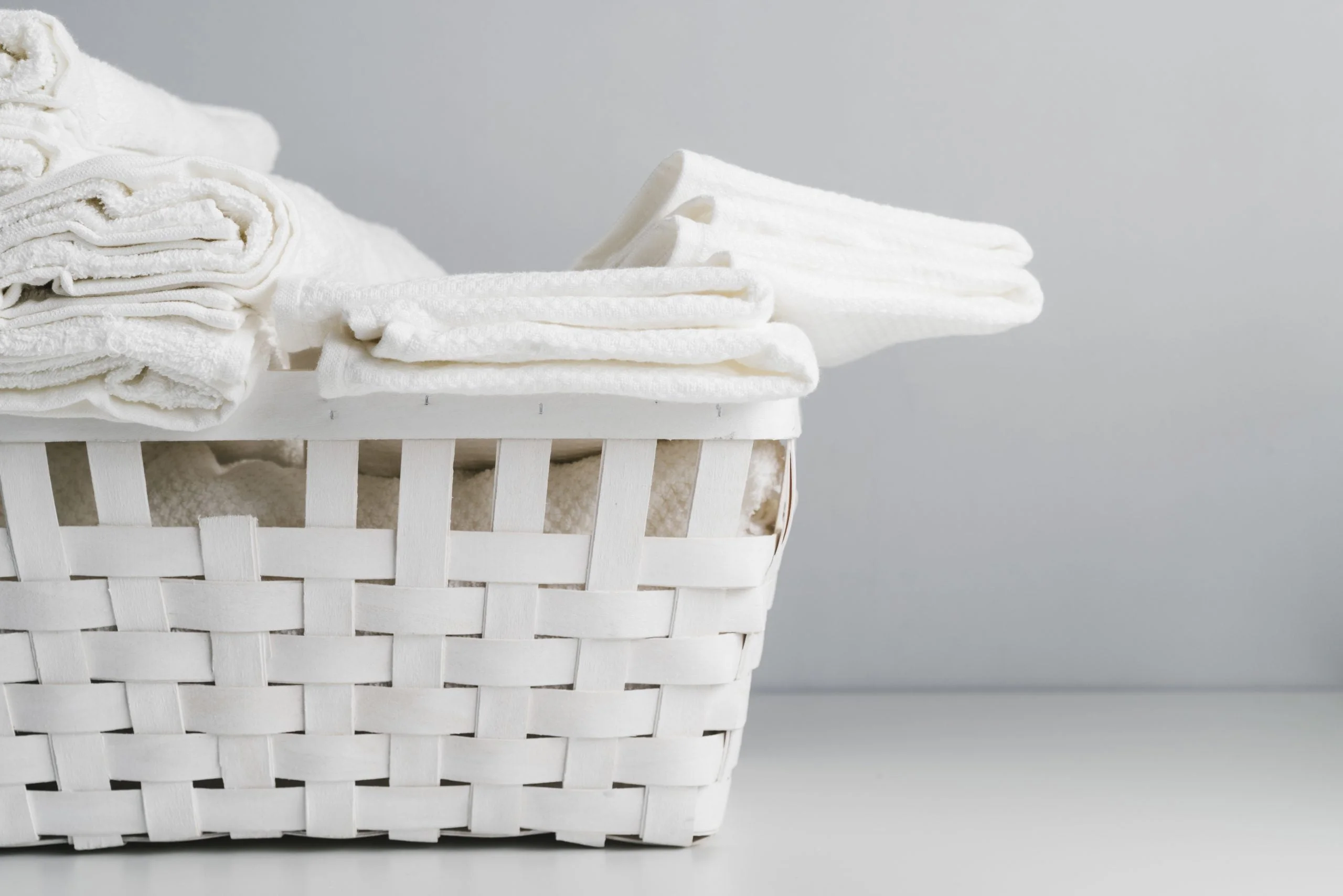 front view white basket with towels